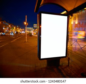 Billboard On The Street Glows At Night. Layout For Advertising Design. Sheet Pylon With A White Field In Stopping Pavilion Bus Shelter Outdoor Advertising