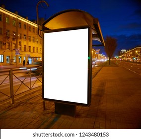 Billboard On The Street Outdoor Advertising Glows At Night. Layout For Advertising Design. Lightposter Pylon With A White Field. Bus Shelter