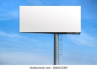 Billboard outdoor advertising, mockup billing board in front of a blue sky. Blank white background for branding design large hoarding