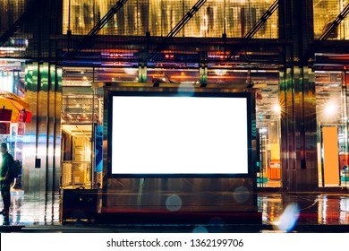 Billboard In Rainy Night With Blank Copy Space Screen For Advertising Or Promotional Publicity Content, Empty Mock Up Lightbox For Information, Blank Display In Urban Street With City Lights