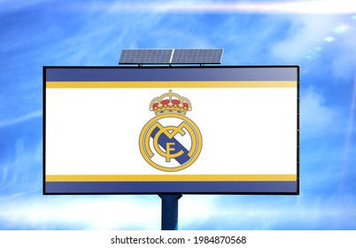 Billboard With Real Madrid Flag And Solar Battery On Blue Sky Background