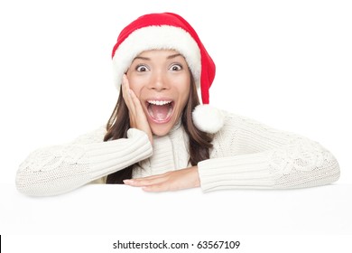 Billboard woman in santa hat leaning on banner for Christmas. Surprised asian beautiful happy model showing blank sign isolated on white background. - Powered by Shutterstock