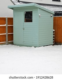 Billericay, Essex, United Kingdom, February 8, 2021. Back Garden Pentland Wooden Shed, Cabin, Hut Or Man Cave. Painted Green. Snowy Winters Day. Billericay, Essex, United Kingdom, February 8, 2021