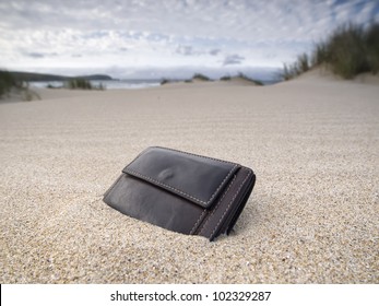 Billfold on the beach over the sand