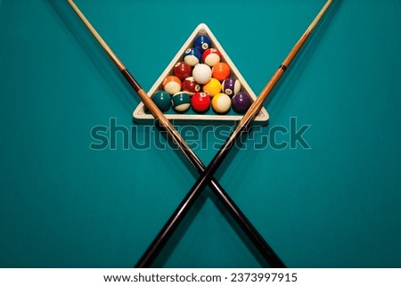 Billiard accessories balls and crossed cues on a billiard table