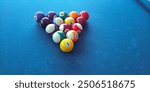 billiard ball arrangement in 8 ball game on blue billiard table