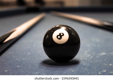 Billiard Ball Figure Eight On A Table With Cues.