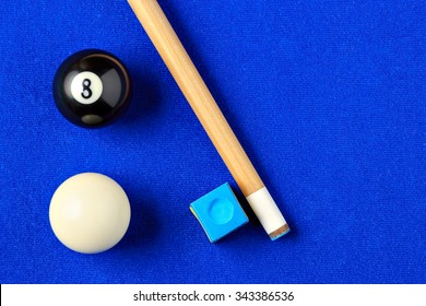 Billiard Balls, Cue And Chalk On A Blue Pool Table. Viewed From Above. Horizontal Image.