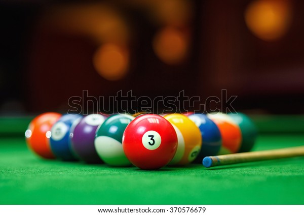 Billiard balls in a\
green pool table, game