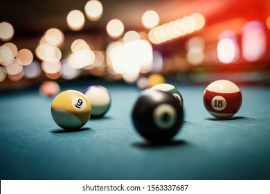 Billiard balls on table. Leisure and gambling concept. Toned image of striped colorful balls
