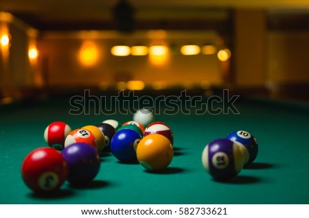 Billiard balls in a pool table.