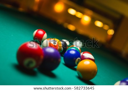 Billiard balls in a pool table.