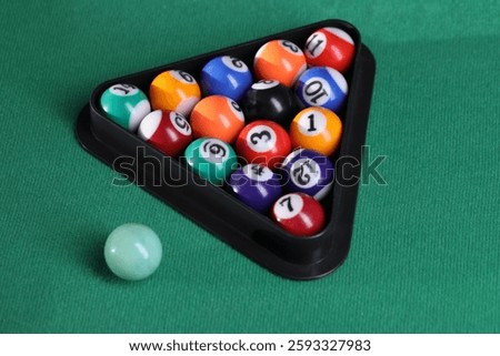 Billiard balls triangle rack on green table, closeup