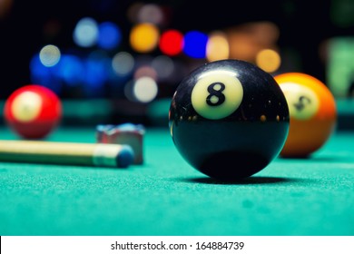 Billiard Balls / A Vintage style photo from a billiard balls in a pool table. Noise added for a film effect
