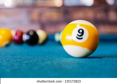 Billiard balls/A Vintage style photo from a billiard balls in a pool table. Noise added for a film effect