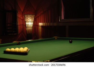 Billiards is a skill sport played using a cue, which is used to push balls around a table covered with canvas