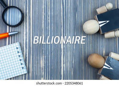 BILLIONAIRE - Word (text) On A Wooden Background, Notepad And Pen With Calculator. Business Concept (copy Space).