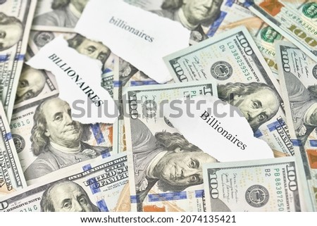 Billionaires income tax. Pile of us dollar banknotes and pieces of paper with Billionaires text. Billionaires income tax proposed in US Senat