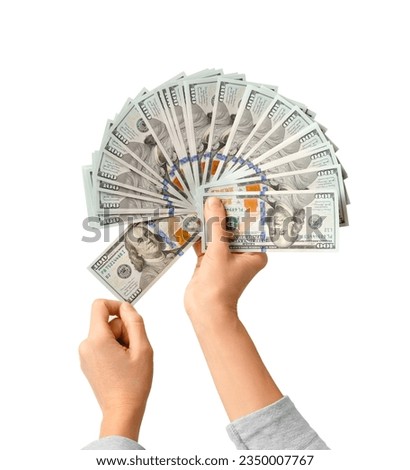 A lot of bills of 100 dollars in hands are folded in a fan on a white background. Currency, banknotes in female hands. The concept of success, business, wealth.