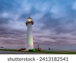 Biloxi Lighthouse at sunrise with dramatic stormy sky in Biloxi, Mississippi, USA.