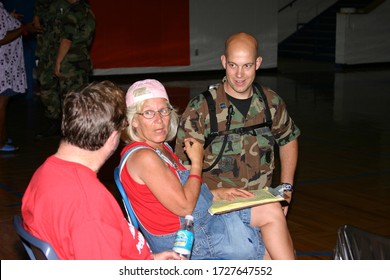 BILOXI, UNITED STATES - Sep 05, 2005: Air Force Reporter And Counselor Speak To Female Hurricane Katrina Survivor.