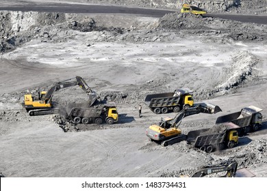 Bilpahari, Pandaveswar, Burdwan, West Bengal, India- December 30, 2017: Coal loading process by JCB and trucks in a coal mining project.