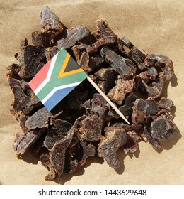 Biltong (dried meat) on a wooden board, this is a traditional food snack that can be found in South Africa.