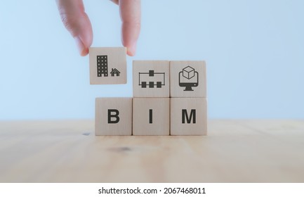BIM Building Information Modeling.  Industry construction, from start to finish. Planner puts wooden cube  with symbol; construction model, information and model simulated program on white background.