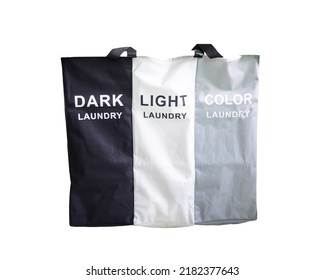 Bin And Dirty Laundry Bag For Black And White And Color Clothes In The Bathroom White Background,color Separation Concept
