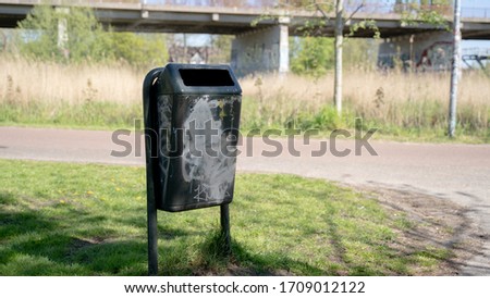 a bin with graffiti on it 