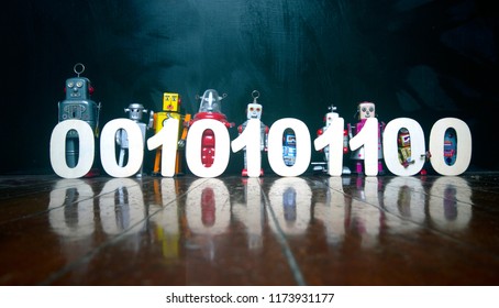 binary cod held by a line of vintage robot toys on a wooden floor with reflection - Powered by Shutterstock - Get 15% off with code: PIKWIZARD15