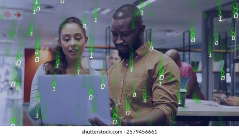 Binary code image over diverse business people working on laptop in office. Technology, teamwork, diversity, innovation, collaboration, coding