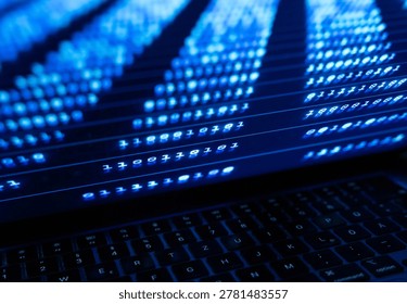 Binary code lines on a laptop screen, computer system data processing. Technology, office, encryption, big data, computer software, coding.