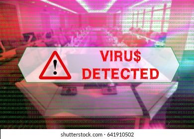 Binary code with the word 'VIRIS DETECTED' in the center with a blurred background of computer labs.