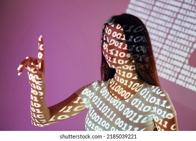 Binary machine code. Beautiful young woman is in projector neon lights in the studio.