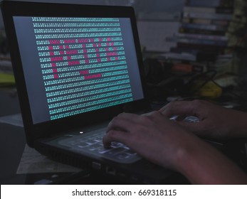 Binary Screen with Petya Virus on Laptop with hand