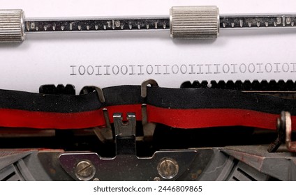 Binary sequence of zeros and ones written in black ink on a white paper with an old typewriter