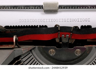 Binary sequence of zeros and ones written in black ink on a paper with an old typewriter