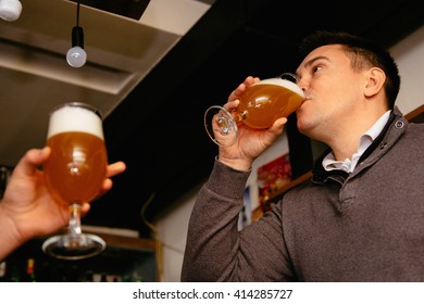 Binge Drinking Beer In Pub