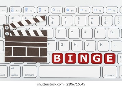 Binge Watching Movies Online With A Keyboard And A Movie Clapper