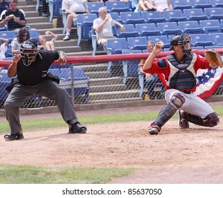 BINGHAMTON, NY - JULY 7: The Umpire Makes A Call As Portland Sea Dogs Catcher Tim Federowicz Throws The Ball In A Game Against The Binghamton Mets At NYSEG Stadium On July 7, 2011 In Binghamton, NY