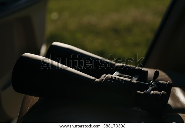 binocular in the car at\
sun