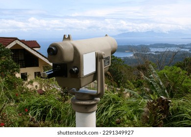 Binocular on the mountain. Tower viewer. Stationary survey telescope with mount receiver. Telescope on the top of the mountain to view the scenery.