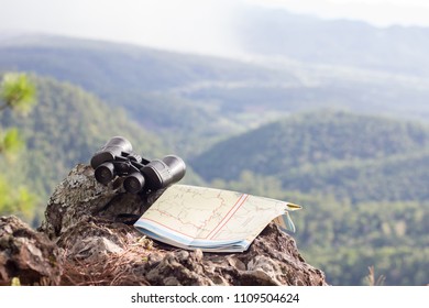 Binoculars and hiking maps are placed on rocky cliffs,  Pictures with space for editing. - Powered by Shutterstock