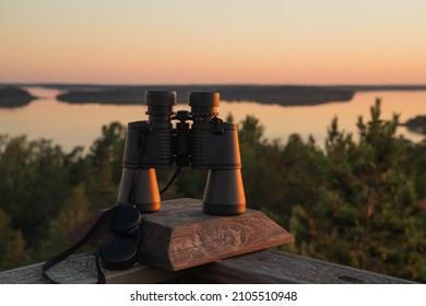 Binoculars On The Background Of Dawn. Nature In Summer. Islands In The Sea. Finland.