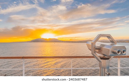 Binoculars on the deck of a cruise ship as it sails off into the sunset. - Powered by Shutterstock