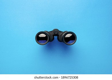 Binoculars on a light blue background. Banner. Flat lay, top view. - Shutterstock ID 1896725308