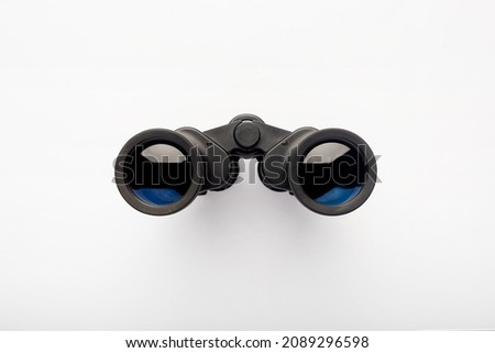 Binoculars on a light white background. Banner. Flat lay, top view.