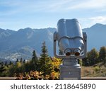 Binoculars on the viewing platform. beautiful panorama of mountains, aerial perspective, distant peaks in a blue haze, freedom and beauty of nature. Autumn view of the Caucasus mountains in Russia