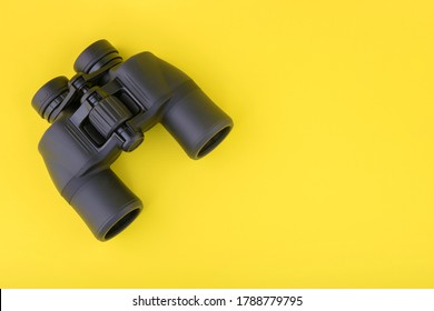 Binoculars on yellow background top view - Shutterstock ID 1788779795